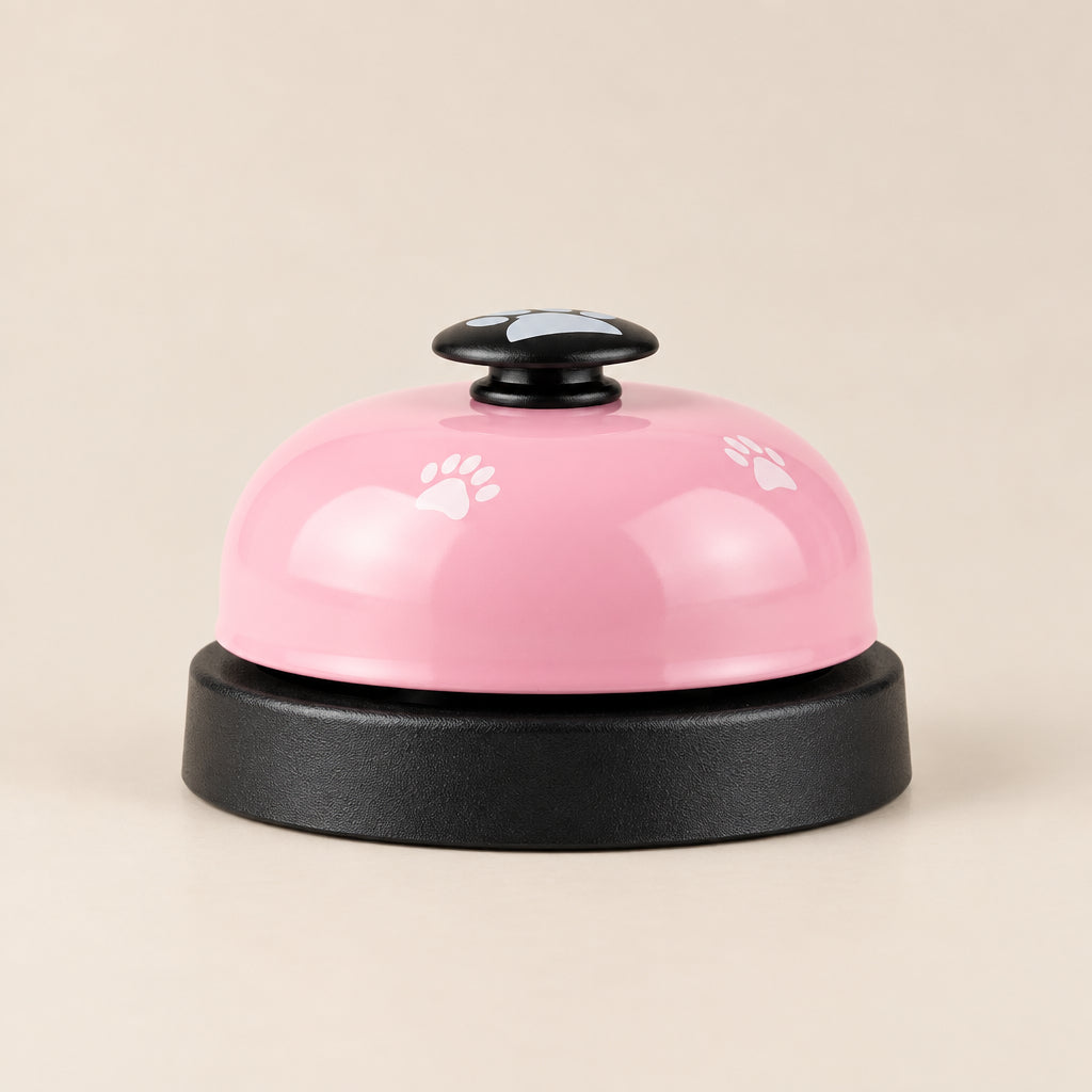 A pink and black bell with paw print details on the dome, set against a clean white background.