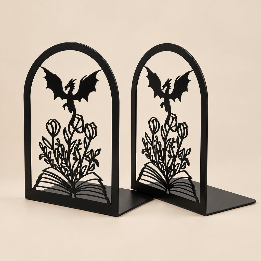 Black metal bookends with dragon and rose design on a beige background