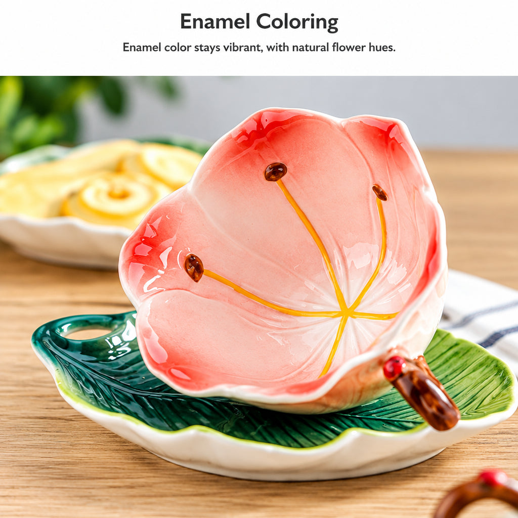 A ceramic flower-shaped cup with a pink and orange interior, yellow petal lines, and a small handle, shown resting on a green leaf-shaped saucer. Text above reads 'Enamel Coloring' with a note about natural flower hues.