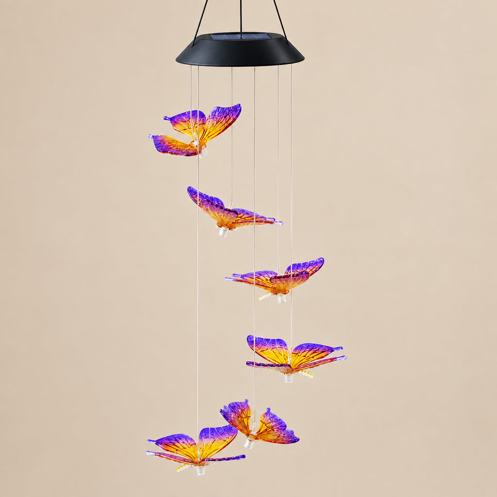 A hanging wind chime ornament featuring six purple and orange butterfly wings suspended from a black conical top with thin metal rods, shown against a plain white background.