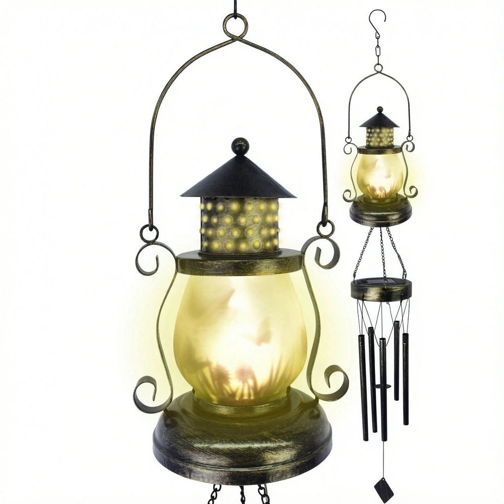 A hanging lantern-style light with a warm glowing glass body and dark metal frame, shown alongside a smaller matching wind chime on a plain white background.
