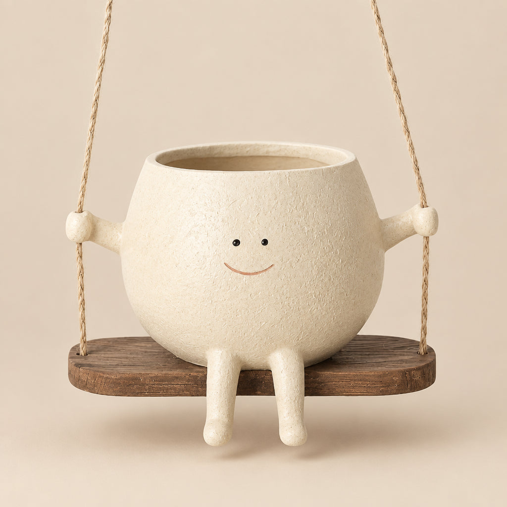 Ceramic planter with legs and a smiling face on a wooden swing