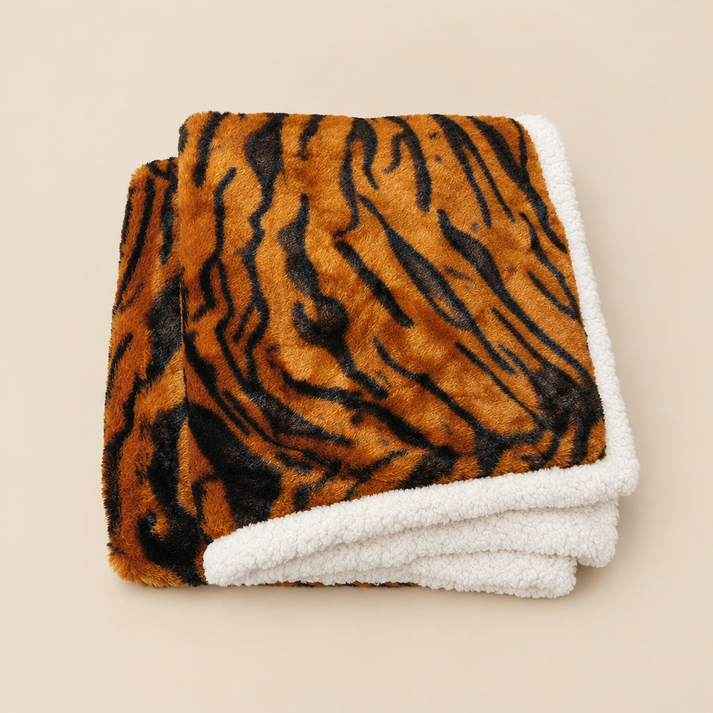 Folded blanket with tiger stripe pattern on a white background