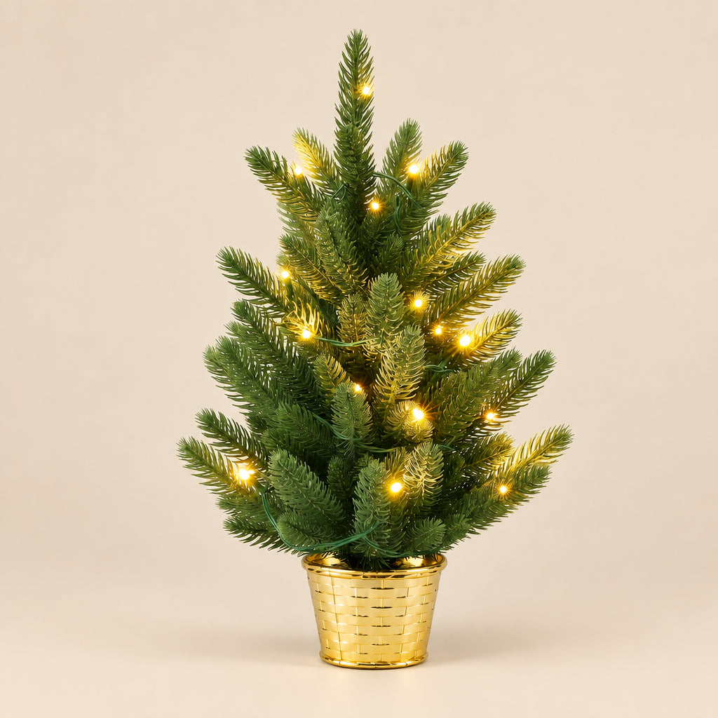 A small artificial Christmas tree with green needles and warm white string lights, displayed in a gold pot against a plain white background.