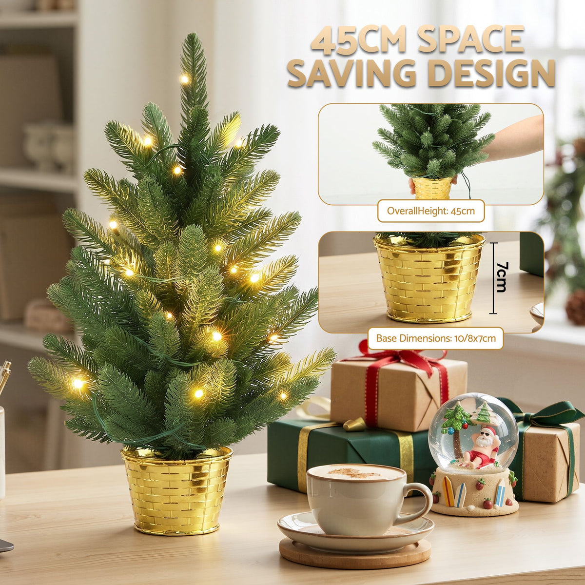 A small artificial Christmas tree in a shiny gold pot with warm white string lights, shown on a tabletop with gift boxes, a cup of coffee, and a snow globe. Text and inset images explain the tree's 45 cm height and base dimensions.